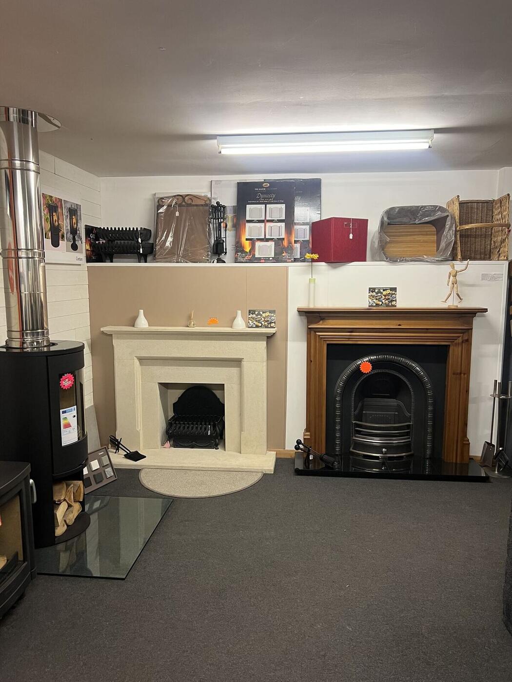 Cream stone surround and wooden fireplace with cast iron insert