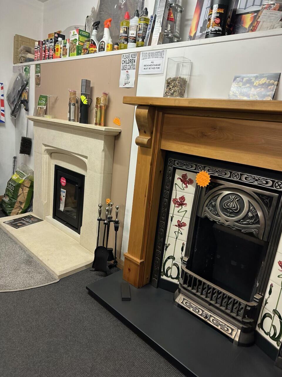 Cream stone surround next to a pine fireplace with floral tiles