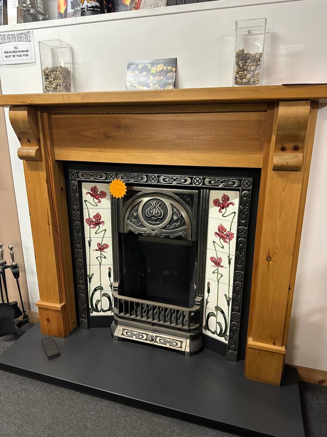 Pine mantel fireplace with Art Nouveau floral tiled insert